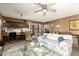Inviting living room with wood paneling, floral sofa, and a seamless flow to the adjacent kitchen at 8602 N 41St Ave, Phoenix, AZ 85051