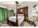 Spacious main bedroom with a four poster bed and a view to the outside at 8602 N 41St Ave, Phoenix, AZ 85051