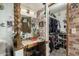 Inside vanity area with brick walls, chair and lighting at 8602 N 41St Ave, Phoenix, AZ 85051