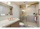 Modern bathroom featuring a glass-enclosed shower with decorative tile, modern vanity, and stylish fixtures at 10305 W Campana Dr, Sun City, AZ 85351
