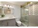Bright bathroom with a modern vanity, geometric tile shower, and updated fixtures at 10305 W Campana Dr, Sun City, AZ 85351