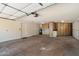 Spacious garage with ample storage cabinets, water heater, and automatic door opener at 10305 W Campana Dr, Sun City, AZ 85351