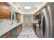 Modern kitchen with stainless steel appliances, white countertops and backsplash, and marble-patterned floors at 10305 W Campana Dr, Sun City, AZ 85351