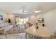 Open-concept living and dining area with plush carpeting, marble floors, and abundant natural light at 10305 W Campana Dr, Sun City, AZ 85351