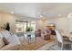 Cozy living room with neutral tones, plush carpeting, and a view to an enclosed patio at 10305 W Campana Dr, Sun City, AZ 85351