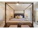 Serene main bedroom suite with four-poster bed, marble floors, and soft lighting at 10305 W Campana Dr, Sun City, AZ 85351