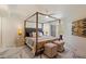 Primary bedroom featuring a four-poster bed, ceiling fan, marble floors, and access to a private patio at 10305 W Campana Dr, Sun City, AZ 85351
