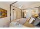Spacious primary bedroom showing a four-poster bed, ensuite bathroom, and ample closet space at 10305 W Campana Dr, Sun City, AZ 85351