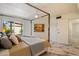 Relaxing primary bedroom showcasing a four-poster bed, marble floors, modern ceiling fan, and access to the outdoor area at 10305 W Campana Dr, Sun City, AZ 85351