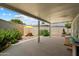 Covered patio featuring decorative metal columns and a privacy wall with mature shrubbery at 10305 W Campana Dr, Sun City, AZ 85351
