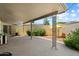 Covered patio featuring decorative metal columns and a privacy wall with mature shrubbery at 10305 W Campana Dr, Sun City, AZ 85351
