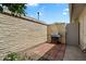 Enclosed patio with brick flooring and stainless steel gas grill at 10305 W Campana Dr, Sun City, AZ 85351