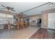 Open dining area with wood table set, decorative shelving, and natural light from multiple windows at 10806 W Adam Ave, Peoria, AZ 85373