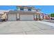 Inviting two-story home displaying a spacious driveway, three-car garage, and roof solar panels at 10806 W Adam Ave, Peoria, AZ 85373