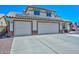 Two-story home with solar panels, a three-car garage, and a spacious driveway at 10806 W Adam Ave, Peoria, AZ 85373
