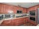 Kitchen showcasing custom wood cabinetry, stainless steel appliances, and ample counter space at 10806 W Adam Ave, Peoria, AZ 85373
