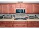 Close up of the kitchen with dark wood cabinets and stainless steel appliances on the countertop at 10806 W Adam Ave, Peoria, AZ 85373