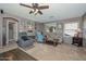 Comfortable living room featuring a ceiling fan, neutral walls, and cozy seating area at 10806 W Adam Ave, Peoria, AZ 85373