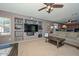 Large living room area with built-in shelving and a view into the kitchen at 10806 W Adam Ave, Peoria, AZ 85373