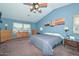 The main bedroom offers lots of space, ceiling fan, light-blocking window coverings, and neutral paint at 10806 W Adam Ave, Peoria, AZ 85373