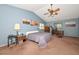 The large main bedroom features a ceiling fan, blue walls, and sunset art at 10806 W Adam Ave, Peoria, AZ 85373