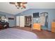 Spacious main bedroom features blue walls, ceiling fan, and access to a full bathroom and the upstairs hallway at 10806 W Adam Ave, Peoria, AZ 85373