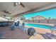 Covered patio offering a relaxing view of the pool and backyard, perfect for outdoor gatherings and leisure at 10806 W Adam Ave, Peoria, AZ 85373