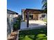 Backyard featuring a covered patio, lush artificial turf, and perimeter landscaping at 1352 W Spine Tree Ave, Queen Creek, AZ 85140