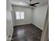 Comfortable bedroom with hardwood floors, ceiling fan, and bright natural light at 1352 W Spine Tree Ave, Queen Creek, AZ 85140