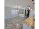 Bright dining room with gray tiling, large window, recessed shelving and modern light fixture at 1352 W Spine Tree Ave, Queen Creek, AZ 85140