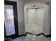Foyer featuring decorative front door and views to a spacious room with modern tiling and a ceiling fan at 1352 W Spine Tree Ave, Queen Creek, AZ 85140