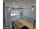 Spacious living room with tiled floors and sliding glass doors to outdoor area at 1352 W Spine Tree Ave, Queen Creek, AZ 85140