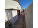 Narrow side yard with storage shed, privacy fence, and brick paver pathway at 1352 W Spine Tree Ave, Queen Creek, AZ 85140