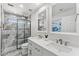 Bathroom featuring double sinks, granite countertop, decorative mirrors, and a tiled walk-in shower at 13626 N 89Th St, Scottsdale, AZ 85260