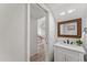 Bathroom with framed mirror, white vanity, and view into the living room at 13626 N 89Th St, Scottsdale, AZ 85260