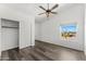 Bright bedroom featuring vinyl wood floors, a ceiling fan, and a sliding door closet at 13626 N 89Th St, Scottsdale, AZ 85260