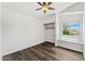 Bedroom with ceiling fan, vinyl floors, closet with sliding door, and a built in bench under the window at 13626 N 89Th St, Scottsdale, AZ 85260