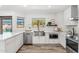 Modern kitchen with stainless steel appliances, quartz countertops, and wood flooring at 13626 N 89Th St, Scottsdale, AZ 85260