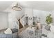 Spacious living room with high ceilings, wood floors, staircase, and modern chandelier at 13626 N 89Th St, Scottsdale, AZ 85260