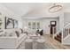 Inviting living room featuring hardwood floors, lots of light, and an elegant chandelier at 13626 N 89Th St, Scottsdale, AZ 85260
