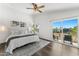 Bright main bedroom features hardwood floors, a ceiling fan, and balcony access at 13626 N 89Th St, Scottsdale, AZ 85260