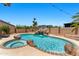 Backyard pool with grotto and attached spa, all surrounded by desert landscaping at 13626 N 89Th St, Scottsdale, AZ 85260