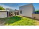 A well-maintained lawn with a gazebo structure and hot tub in the backyard at 1409 E Apollo Rd, Phoenix, AZ 85042