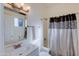 A bathroom featuring a shower-tub, vanity, framed mirror, and towel rack at 1409 E Apollo Rd, Phoenix, AZ 85042