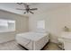 This bedroom features neutral walls, wood-look tile floors, a ceiling fan and two windows at 1409 E Apollo Rd, Phoenix, AZ 85042