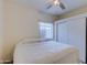 Bright bedroom boasts ceiling fan, window and a closet with sliding doors at 1409 E Apollo Rd, Phoenix, AZ 85042