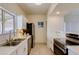 Bright kitchen features stainless steel appliances, tiled backsplash, and a stainless steel sink at 1409 E Apollo Rd, Phoenix, AZ 85042