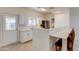 Updated kitchen boasts bright cabinets, stainless steel appliances, breakfast bar and neutral countertops at 1409 E Apollo Rd, Phoenix, AZ 85042