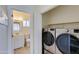 The laundry room features a washer, dryer and access to the bathroom at 1409 E Apollo Rd, Phoenix, AZ 85042