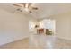 Spacious living room featuring tile flooring, bright lighting, and an open layout connecting to the kitchen and dining area at 1409 E Apollo Rd, Phoenix, AZ 85042
